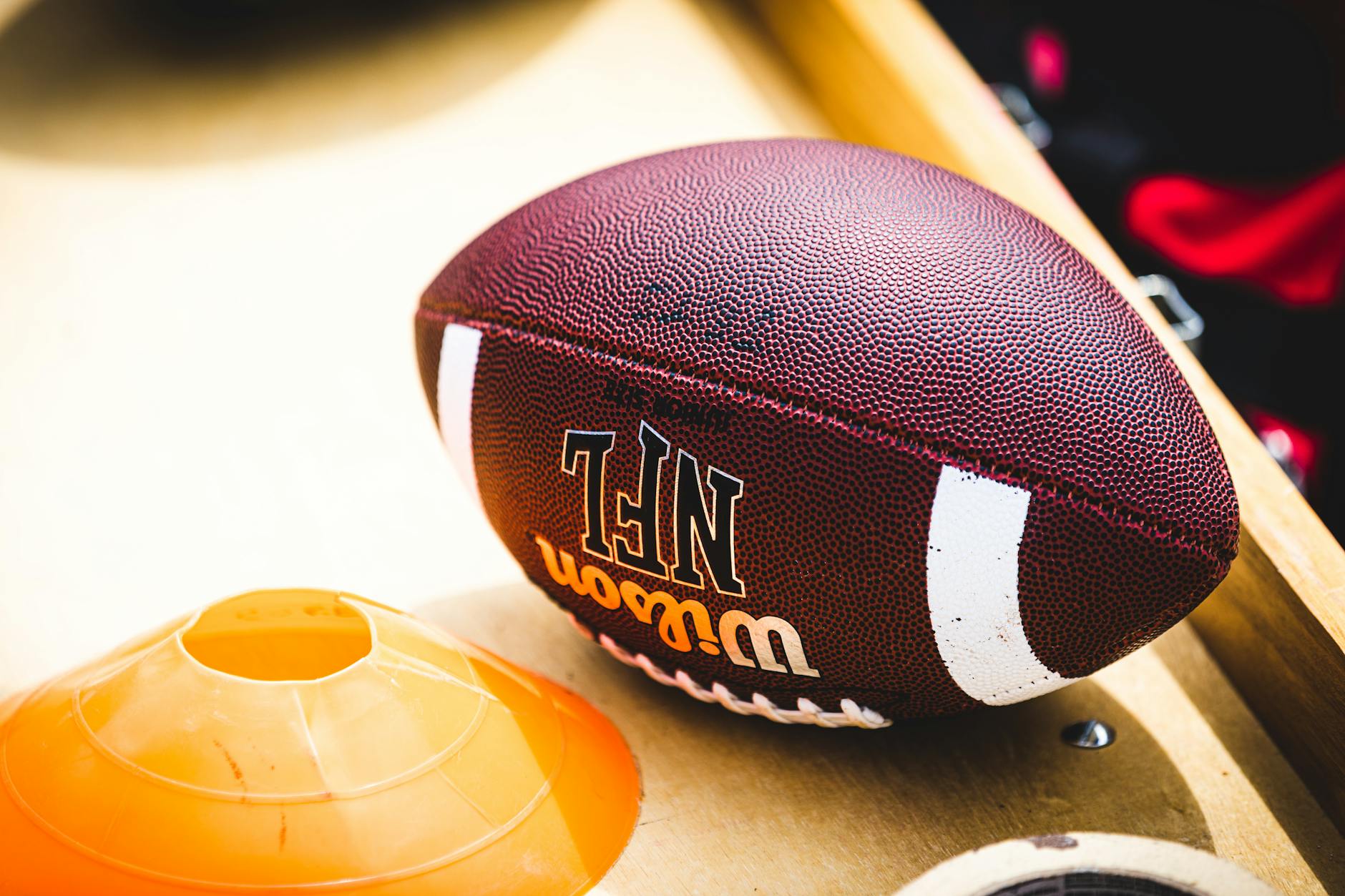 American football on a sideline bench at a stadium